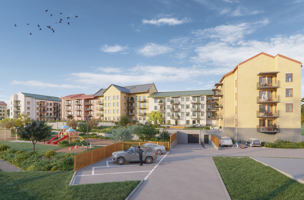 Översikt över en grönskande innergård med parkering och lekplats, hela kvarteret alla hus i bakgrun